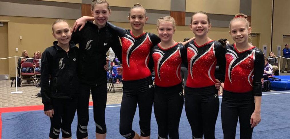 Athletes Sophia, Sophia, Alaina, Lila, Ashlyn, and Sofia pose for a picture before competition.